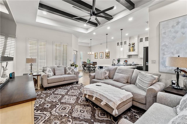 16593 W Mccullar Ct, Harlingen, TX 78552 - living room with ceiling fan, light wood finished floors, recessed lighting, beam ceiling, and a chandelier