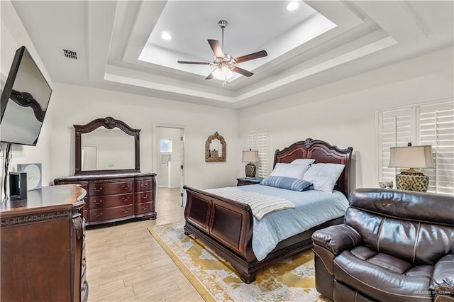 16593 W Mccullar Ct, Harlingen, TX 78552 - bedroom featuring a tray ceiling, light wood finished floors, recessed lighting, and a ceiling fan