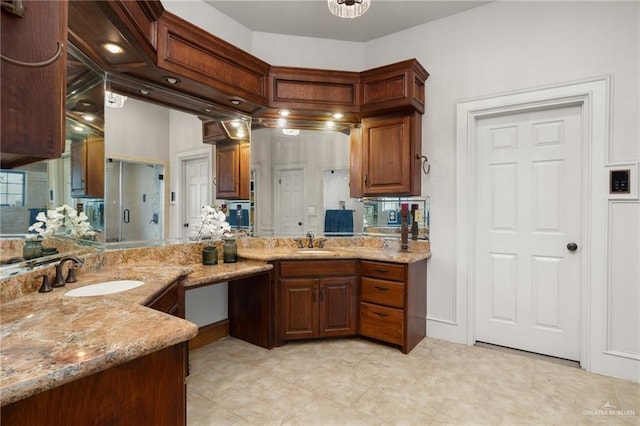 kitchen featuring light stone counters and sink