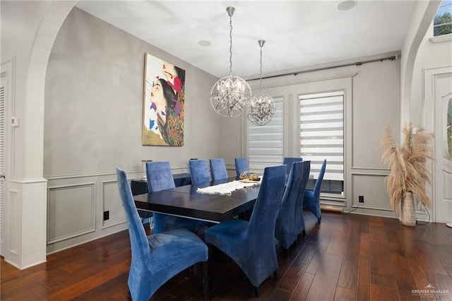 dining space featuring an inviting chandelier and dark hardwood / wood-style flooring