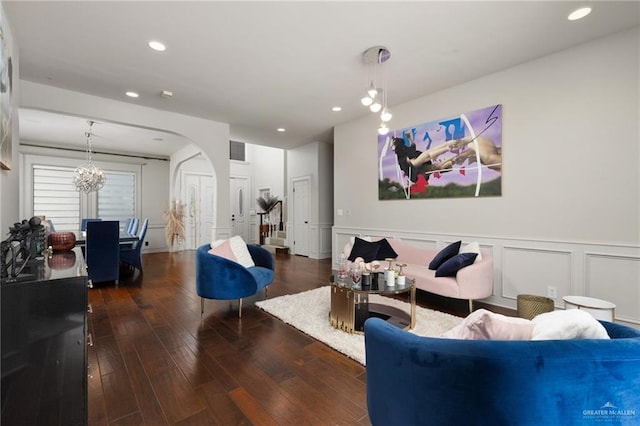 living room with dark hardwood / wood-style floors and a chandelier