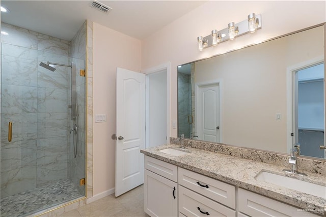 bathroom featuring tile patterned floors, vanity, and an enclosed shower