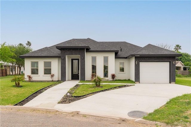 prairie-style house with a garage and a front lawn