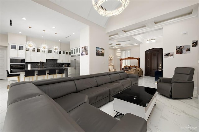 living area featuring marble finish floor, coffered ceiling, beamed ceiling, a high ceiling, and recessed lighting