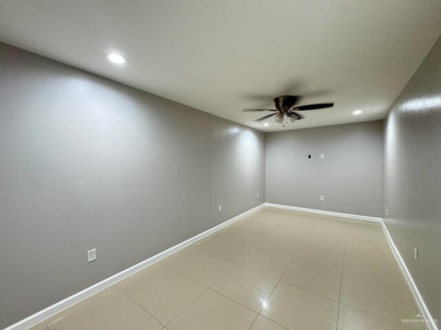 spare room with light tile patterned flooring and ceiling fan