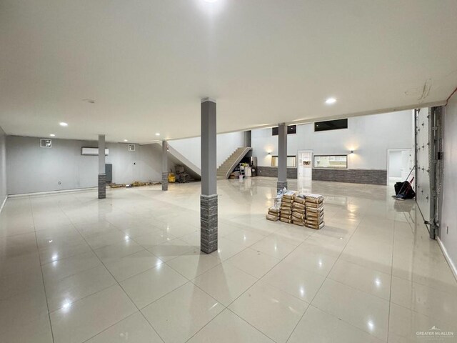 basement featuring light tile patterned flooring