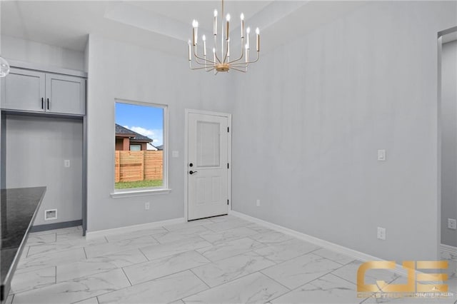 unfurnished dining area with an inviting chandelier