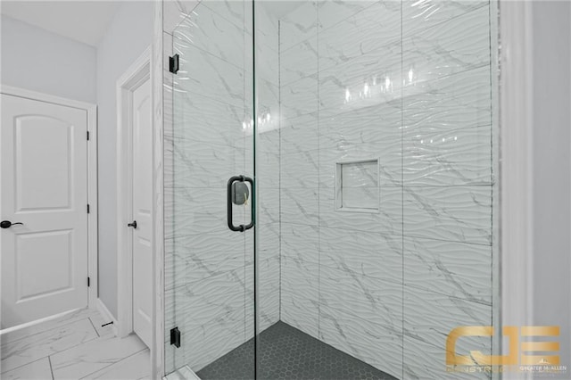 bathroom featuring a shower with shower door