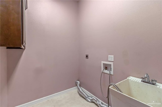 washroom with hookup for an electric dryer, cabinets, sink, and hookup for a washing machine