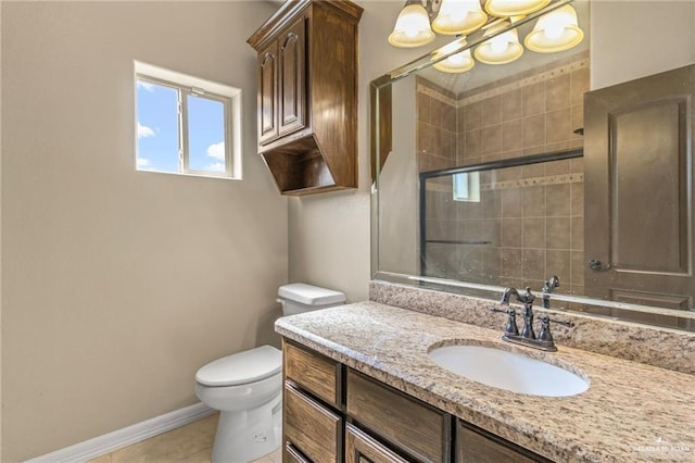 bathroom featuring tile patterned floors, vanity, toilet, and an enclosed shower