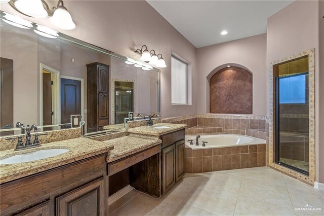 bathroom with vanity, tile patterned flooring, and plus walk in shower