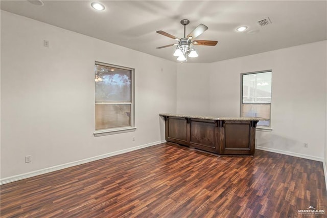 empty room featuring dark hardwood / wood-style floors and ceiling fan