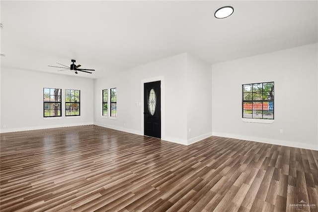 unfurnished living room featuring hardwood / wood-style floors and ceiling fan