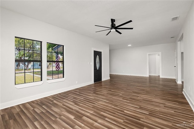 empty room featuring ceiling fan and dark hardwood / wood-style floors