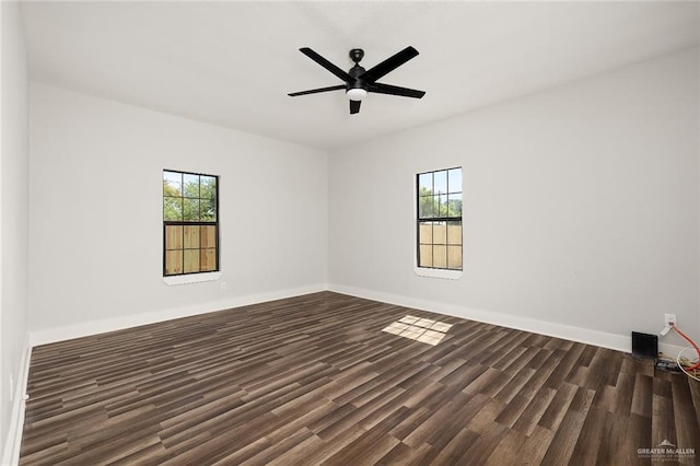 empty room featuring dark hardwood / wood-style flooring and ceiling fan