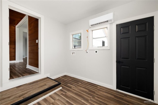 entrance foyer featuring dark wood-type flooring and a wall mounted AC