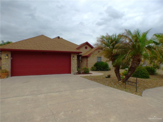 3319 Country Club Dr N, Edinburg, TX 78542 - view of front of property with driveway, an attached garage, a shingled roof, and brick siding