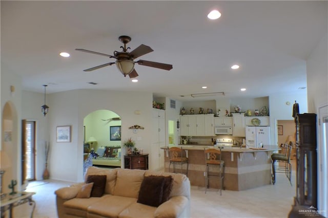 3319 Country Club Dr N, Edinburg, TX 78542 - living area with arched walkways, a ceiling fan, and recessed lighting