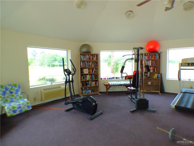 3319 Country Club Dr N, Edinburg, TX 78542 - workout area with vaulted ceiling, ceiling fan, a wall mounted air conditioner, carpet flooring, and baseboards