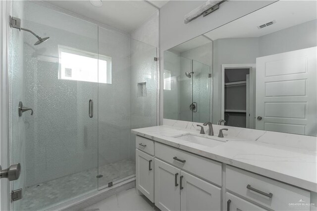 bathroom featuring vanity and an enclosed shower