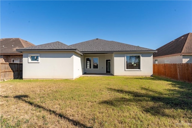 rear view of house with a lawn