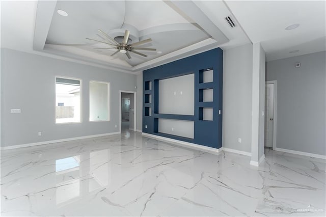 spare room with a tray ceiling and ceiling fan