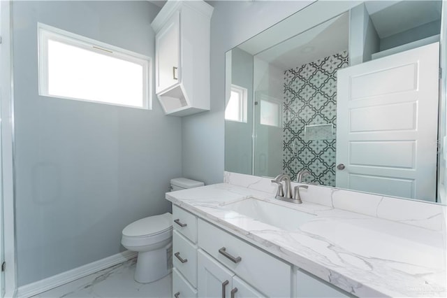 bathroom featuring a shower, vanity, and toilet