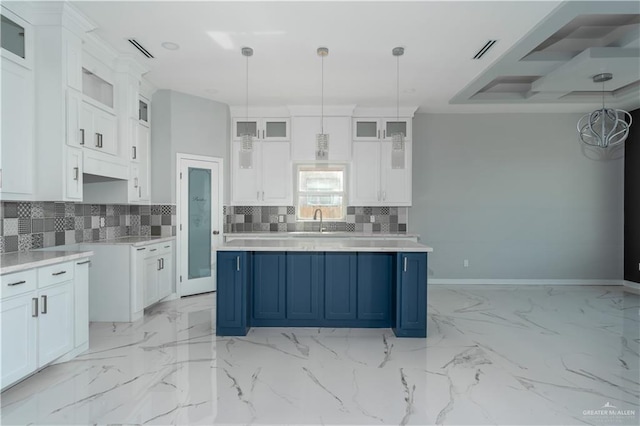 kitchen featuring decorative light fixtures, a kitchen island, white cabinetry, and blue cabinets