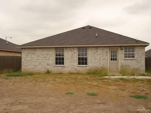 719 W Sherryl Ave, Pharr, TX 78577 - rear view of property featuring a shingled roof and fence