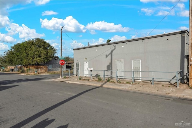 exterior space featuring curbs, traffic signs, and sidewalks