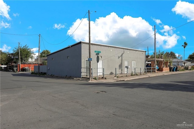 view of building exterior with fence