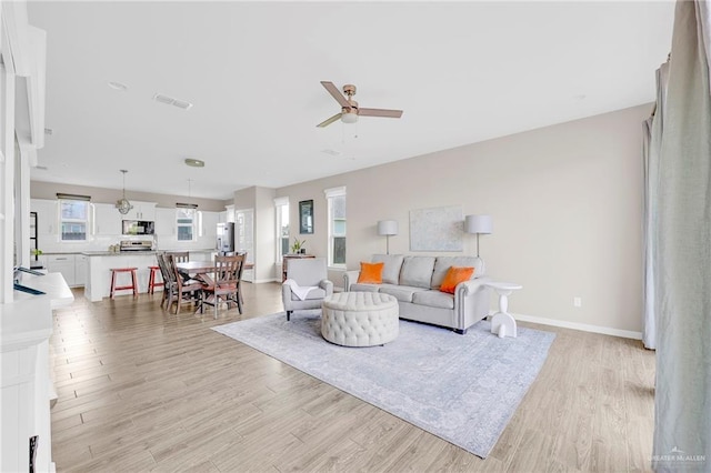 5237 Lost Creek Ln, Mcallen, TX 78504 - living area with a ceiling fan and light wood-style floors