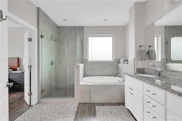 5237 Lost Creek Ln, Mcallen, TX 78504 - ensuite bathroom featuring wood finished floors, a garden tub, vanity, and a shower stall
