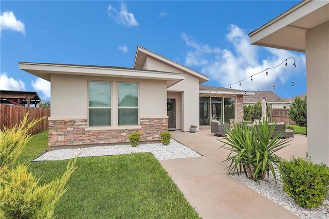 5237 Lost Creek Ln, Mcallen, TX 78504 - rear view of house featuring stucco siding, stone siding, a patio, and a sunroom