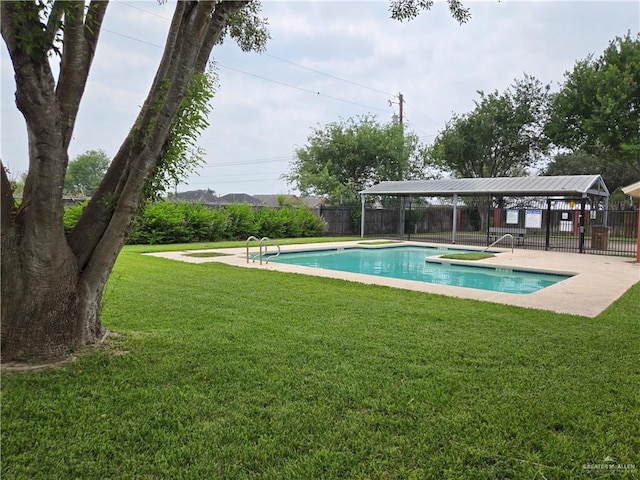 view of pool with a lawn and a patio area