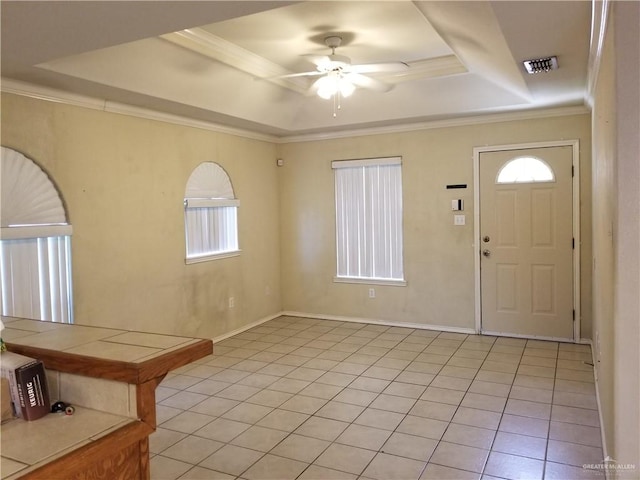 foyer featuring light tile patterned floors, a tray ceiling, ceiling fan, and crown molding