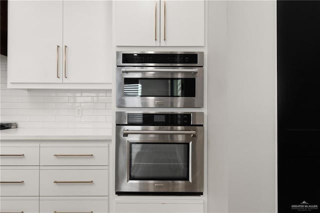 1426 Kalob Cir, Harlingen, TX 78552 - kitchen featuring double oven, light countertops, white cabinets, and tasteful backsplash