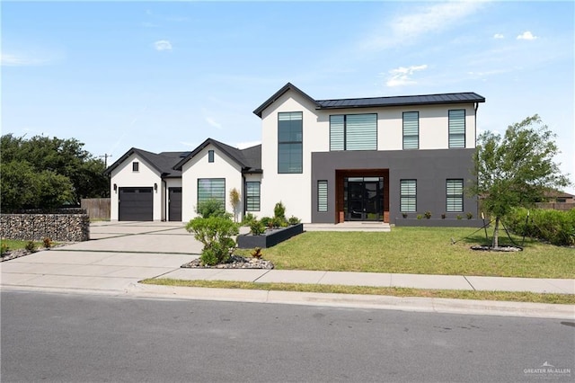 1426 Kalob Cir, Harlingen, TX 78552 - view of front of property featuring stucco siding, a standing seam roof, driveway, and a front lawn