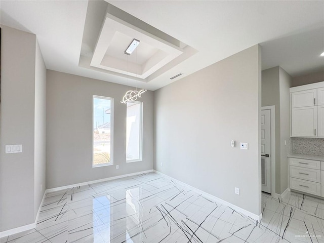 unfurnished room with a tray ceiling