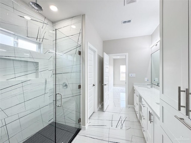 bathroom with vanity and a shower with shower door