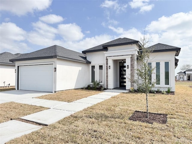 prairie-style home with a garage and a front yard