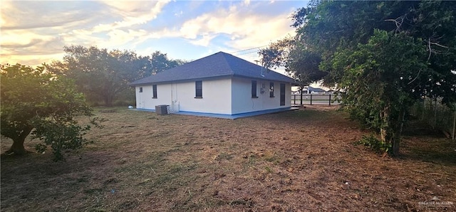 property exterior at dusk with central air condition unit