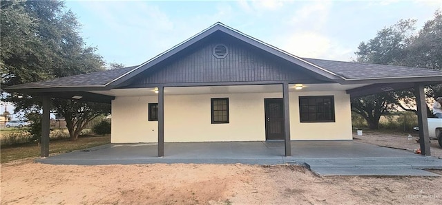 back of property featuring a carport