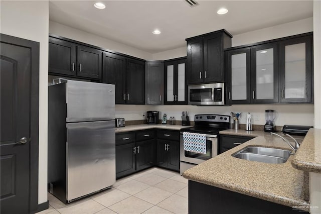 1304 E Camellia Ave Unit 2, Mcallen, TX 78501 - kitchen with light tile patterned floors, dark cabinets, appliances with stainless steel finishes, and a sink