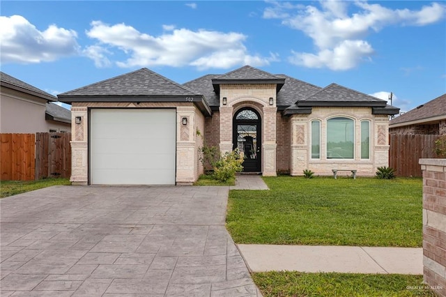 502 Oak Ridge St, Donna, TX 78537 - french provincial home featuring concrete driveway, a garage, roof with shingles, and brick siding