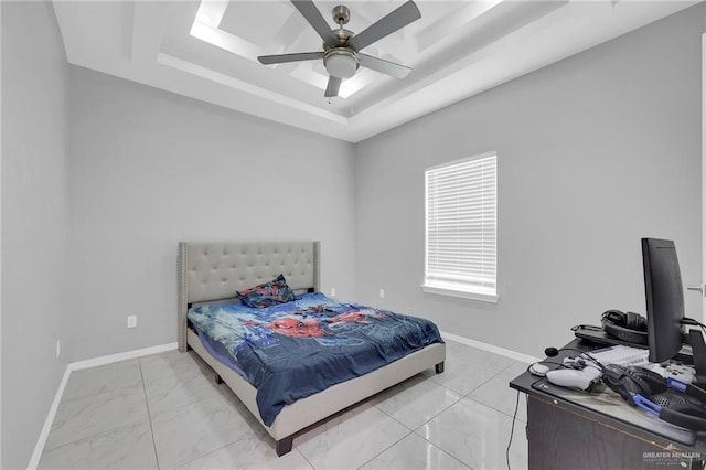 502 Oak Ridge St, Donna, TX 78537 - bedroom with light marble finish floors, a tray ceiling, and a ceiling fan