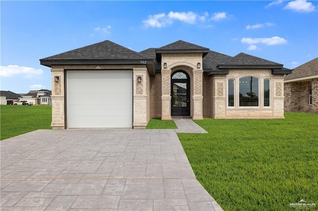 502 Oak Ridge St, Donna, TX 78537 - french country style house featuring a front yard, an attached garage, and a shingled roof
