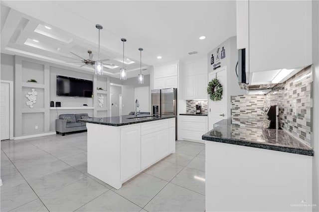 502 Oak Ridge St, Donna, TX 78537 - kitchen featuring ceiling fan, stainless steel fridge, white cabinetry, backsplash, and dark stone counters