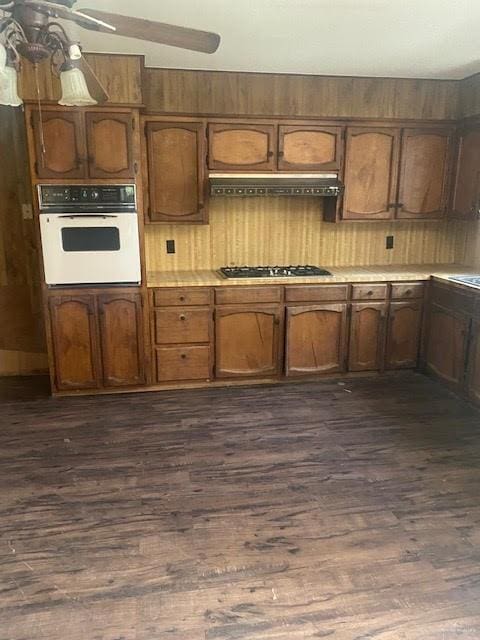 223 W Schunior St, Edinburg, TX 78541 - kitchen with white oven, dark wood finished floors, light countertops, and stainless steel gas cooktop