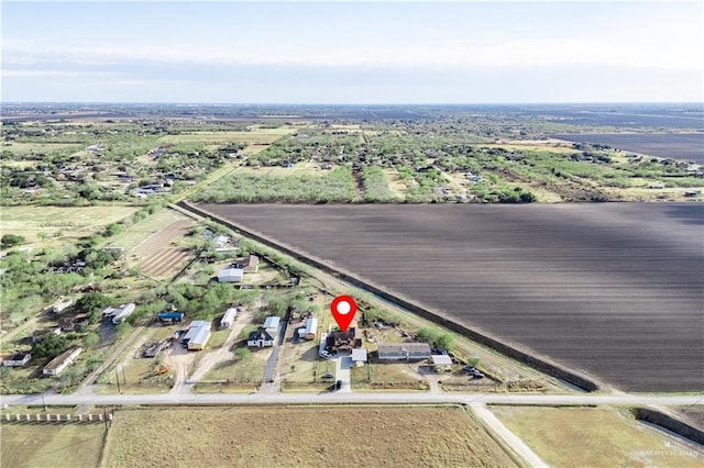 birds eye view of property with a rural view